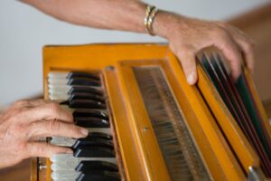 hands playing a harmonium