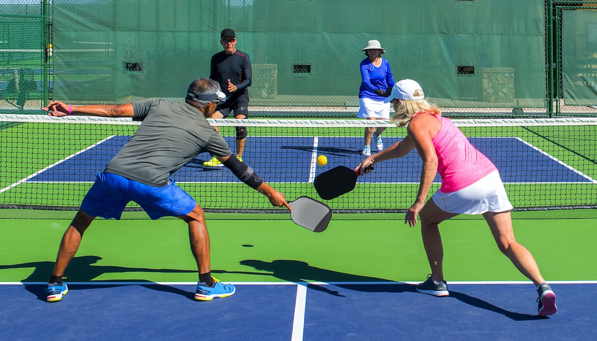 stock-photo-pickleball-mixed-doubles-action-of-colorful-court-618134954-2